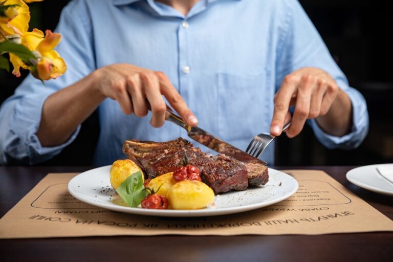 man eating steak